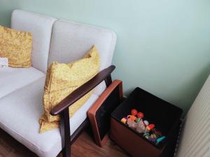 a living room with a couch and a box of toys at TAAY -Luxurious 3 bedroom house in South Norwood