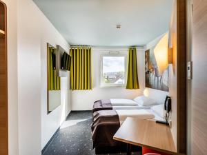 Postel nebo postele na pokoji v ubytování B&B Hotel Weil am Rhein/Basel