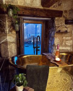 bañera en una habitación con ventana en The Cowshed, en Llangollen