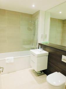 a bathroom with a toilet and a sink and a shower at Brand new gorgeous 2 bed Apt in Finnieston in Glasgow
