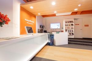 an office with a reception counter and a refrigerator at easyHotel Maastricht City Centre in Maastricht +77 photos