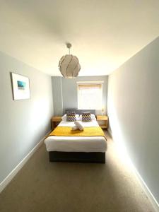 a bedroom with a bed and a chandelier at 2 Bedroom Apt in the Heart of the City Centre, perfect Location in Glasgow
