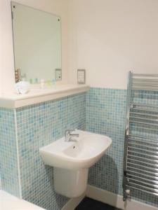 a bathroom with a sink and a mirror at 2 Bedroom Apt in the Heart of the City Centre, perfect Location in Glasgow
