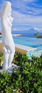 a statue of a woman looking out at the ocean at Villa Ulyana Kriaritsi - Athos Sea View & Spa in Kriaritsi