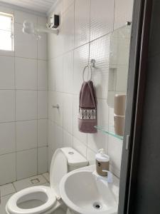 een witte badkamer met een toilet en een wastafel bij Suite MC in Jericoacoara