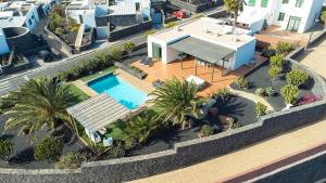 an aerial view of a house with a swimming pool at Villa Papagayo Lanzarote in Playa Blanca