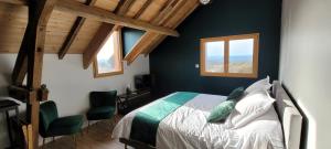 a bedroom with a bed and two windows at Le petit nid du Quercy in Anglars-Nozac +48 photos