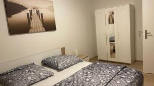 a bedroom with a bed with two pillows and a mirror at Apartement Fürth close Nürnberg in Fürth