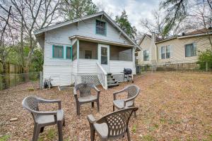 a house with four chairs in front of it at Charming Hot Springs Home Less Than 2 Mi to Bathhouse Row! in Hot Springs