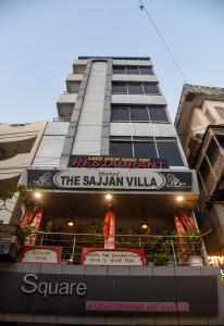 a tall building with a sign that reads the saulian village at Sajjan Villa in Udaipur