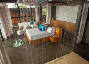 a bedroom with a bed and a table and chairs at Kura Boutique Hotel Member of the Cayuga Collection in Uvita