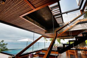 a staircase in a house with a view of the ocean at Kura Boutique Hotel Member of the Cayuga Collection in Uvita