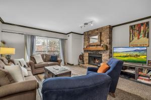 a living room with two couches and a fireplace at Modern 2BR Condo Near Ski Lift Walk Everywhere in Park City