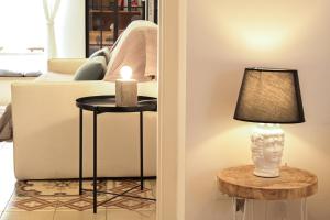 a living room with a couch and a candle on two tables at CASA RICASOLI by MANZONI COLLECTION in Monopoli