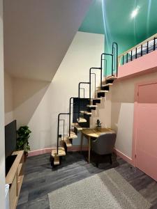 um quarto com uma escada com uma mesa e um lavatório em Cozy En-suite Loft in Trendy Local em Londres