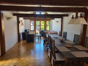 a dining room with a large wooden table and chairs at Gästehaus Harzstraße in Schladen