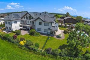 an aerial view of a large house with a yard at LIEBLINGSPLATZ, elegant apartment, countryside in Seekirchen am Wallersee