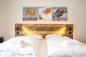 a bed with white pillows and a wooden headboard at Smart Resorts Topas 301 in Winterberg +7 photos