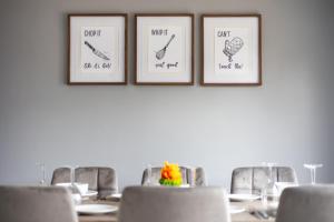 a dining room with a table with chairs and three pictures on the wall at Lofthouse M1 M62 - Parking, En-suite Bedrooms, Wi-Fi, Workspace, Smart TV's, Self Check-in, Garden - Contractors, Families, Long Stays - Alt-Stay in Wakefield