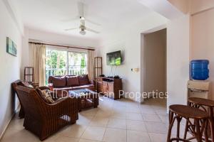 a living room with a couch and a table at Alicia Beach, Hispanola Sol, Sosua Center, guest friendly! in Sosúa