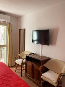 a hotel room with a bed and a flat screen tv at SOLEMARE in Palau