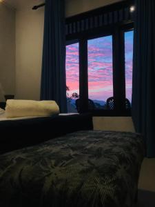 a bedroom with a bed in front of a window at Cloud Nine in Kandy