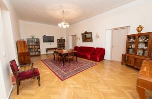 a living room with a red couch and a table at Anna's Guest House in Gori