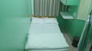 a small room with two beds with white pillows at Ruby Star Hostel Dubai G P-34567 in Dubai