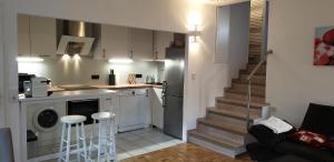 a small kitchen with a staircase leading to a living room at Apartement Fürth close Nürnberg in Fürth