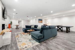 a living room with a couch and a table at Grand Retreat - Luxury Vacation for Large Groups in Fayetteville