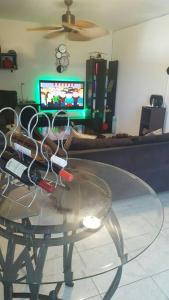a glass table with scissors on top of it in a living room at The Biltons - 6 min from airport- A/C in all rooms in Montego Bay
