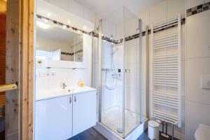 a bathroom with a shower and a sink at Leuchtturm 10 in Großenbrode +56 photos