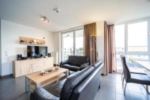 a living room with a couch and a table at Leuchtturm 10 in Großenbrode