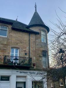 a large brick building with a tower on top of it at Parkview in Dunkeld