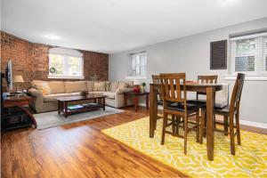 a kitchen and living room with a table and chairs at City Living In the Heart of 4th Ward~1BD 1BA in Charlotte
