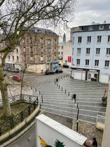 a group of stairs in a city with buildings at Place St Vincent de Paul, Le Havre in Le Havre