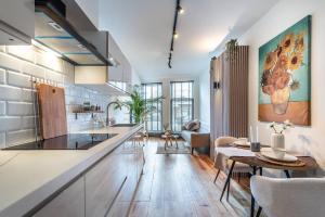 a large kitchen with a counter and a table at CanalView Luxury Apartment in Amsterdam