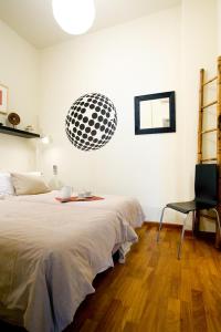 a bedroom with a bed and a desk and a chair at Picasso Apartment in Barcelona