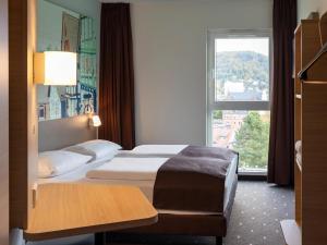 a hotel room with a bed and a window at B&B Hotel Marburg in Marburg an der Lahn