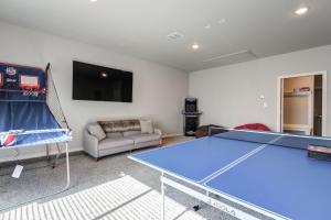 a living room with a ping pong table and a tv at Entire House~ Spacious~ Prime Location~ Backyard in Lubbock