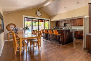 a kitchen and dining room with a table and chairs at Resort style back yard heated pool and spa in Encinitas