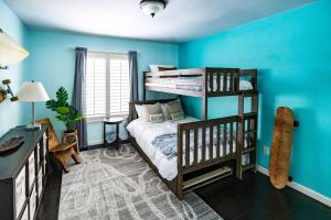 a bedroom with blue walls and a bunk bed at Resort style back yard heated pool and spa in Encinitas