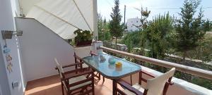 a balcony with a table and chairs on a balcony at Actis studios 1 in Stelida +41 photos