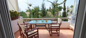 a table and chairs sitting on a balcony with a view at Actis studios 1 in Stelida