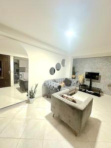 sala de estar amplia con sofá y TV en Amplio y lindo apartamento, en Medellín