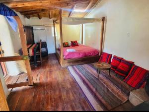 ein Schlafzimmer mit einem Bett und einem Sofa darin in der Unterkunft Wolf Totem Mountain Top Dream Villa in Pisac