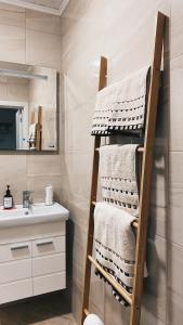 a towel rack in a bathroom with a sink at Brand new, luxury beach flat in Tsarevo