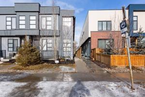 an empty street in a city with buildings at Bluewaters in Kensington in Calgary