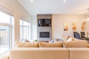 a living room with a couch and a fireplace at Bluewaters in Kensington in Calgary