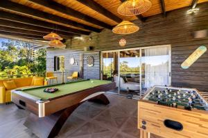 a living room with a pool table and a pool table at Modern village between mountains Villa la Justina in Constanza